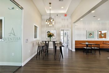 a dining room with a table and chairs in front of a glass door  at Aventura at Hawk Ridge, Lake St Louis